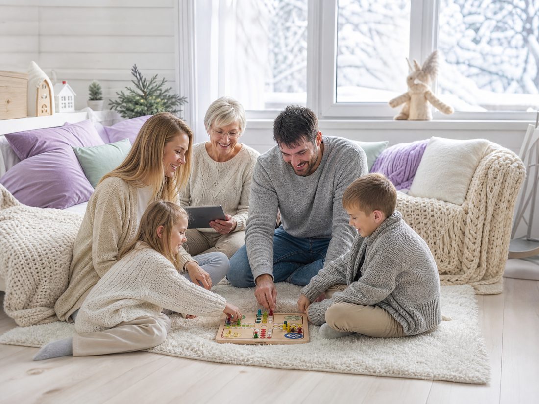 People playing a board game together at a table in soft indoor light